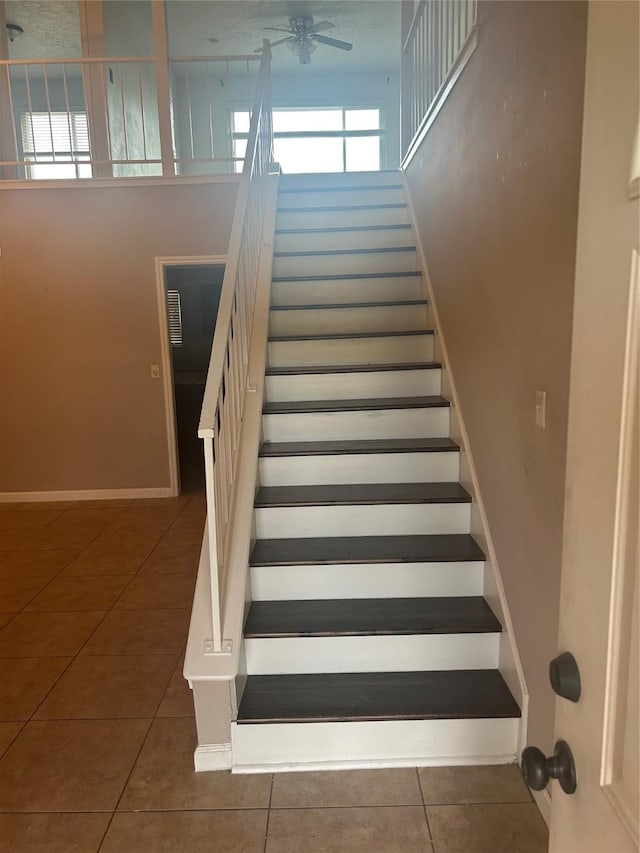 13507 White Cliff Dr, Houston, TX 77065 - stairway with tile patterned flooring, ceiling fan, and baseboards