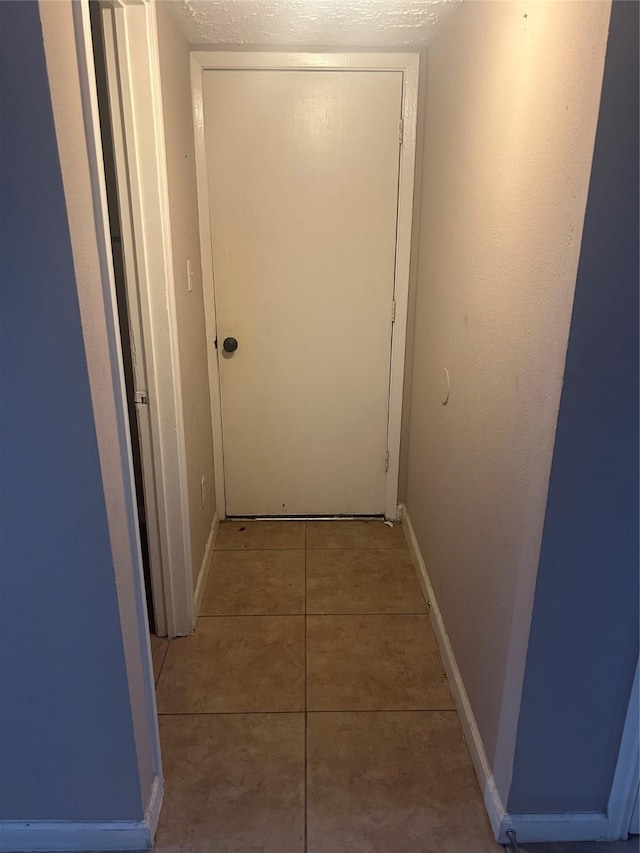 13507 White Cliff Dr, Houston, TX 77065 - corridor featuring light tile patterned flooring and baseboards