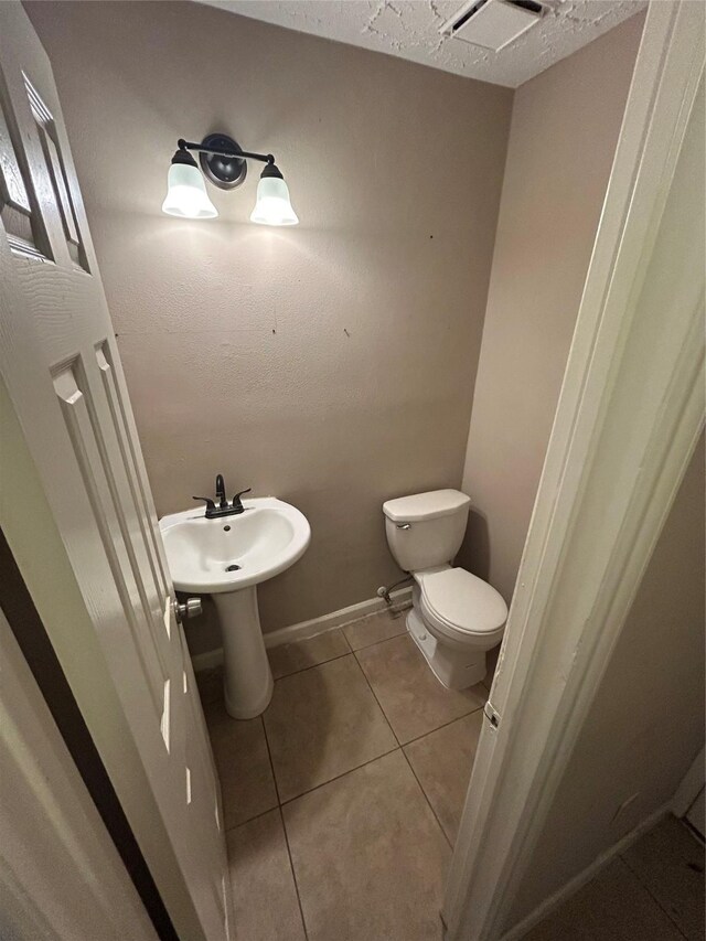 13507 White Cliff Dr, Houston, TX 77065 - half bath featuring tile patterned flooring, toilet, and a sink