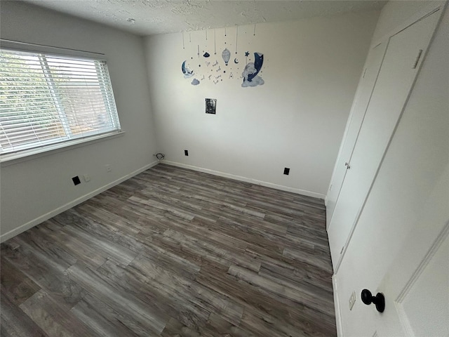 13507 White Cliff Dr, Houston, TX 77065 - laundry area featuring dark wood-style flooring, a textured ceiling, and baseboards