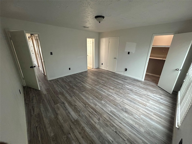 13507 White Cliff Dr, Houston, TX 77065 - unfurnished bedroom featuring wood finished floors, baseboards, and a textured ceiling