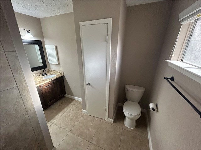 13507 White Cliff Dr, Houston, TX 77065 - bathroom featuring tile patterned flooring, toilet, vanity, a textured ceiling, and baseboards