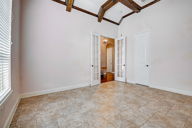 6315 Asbury Brook Ct, Katy, TX 77493 - unfurnished bedroom with french doors, baseboards, beamed ceiling, arched walkways, and a towering ceiling