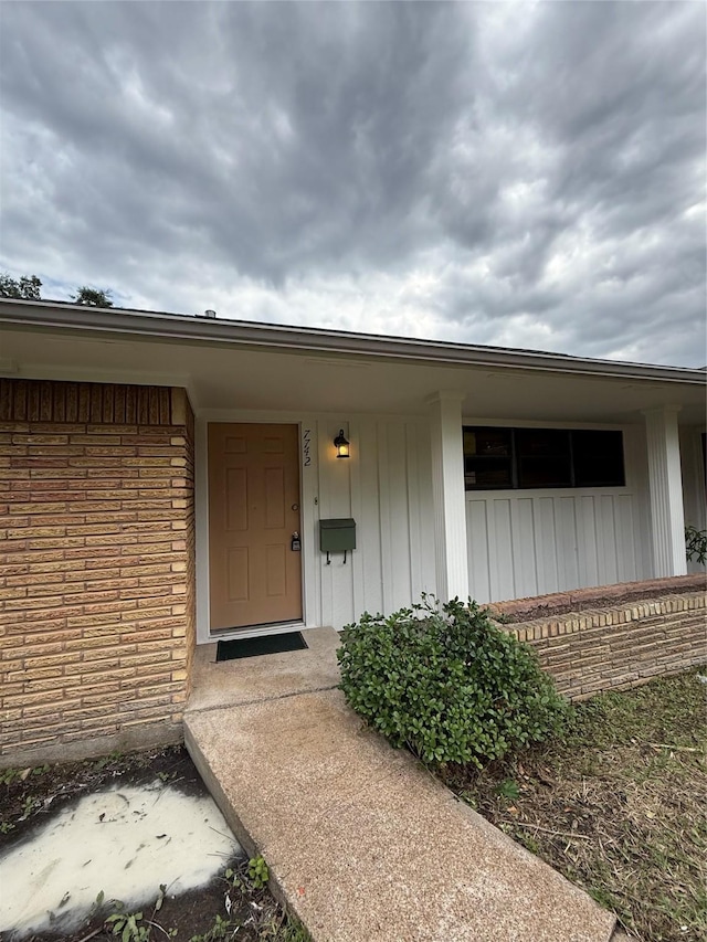 property entrance with brick siding