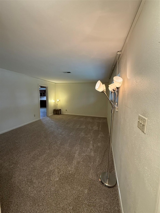 carpeted spare room with baseboards