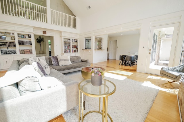 11810 Braesridge Dr, Houston, TX 77071 - living room featuring wood finished floors, high vaulted ceiling, and built in shelves