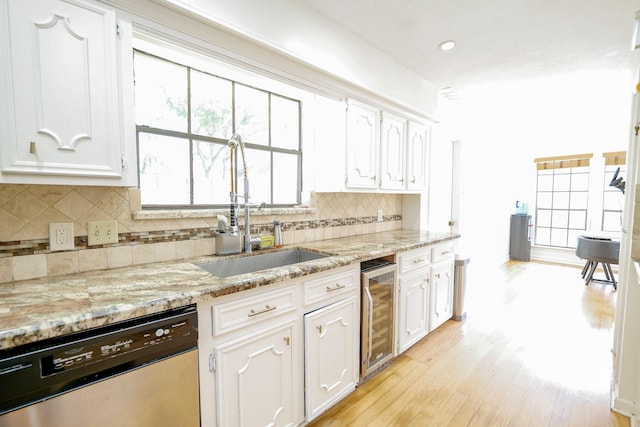 11810 Braesridge Dr, Houston, TX 77071 - kitchen featuring dishwasher, wine cooler, white cabinets, a sink, and light wood finished floors