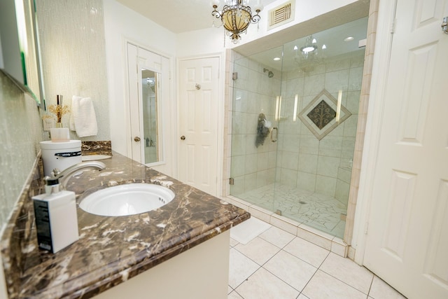 11810 Braesridge Dr, Houston, TX 77071 - full bathroom featuring a shower stall, double vanity, tile patterned floors, and a chandelier