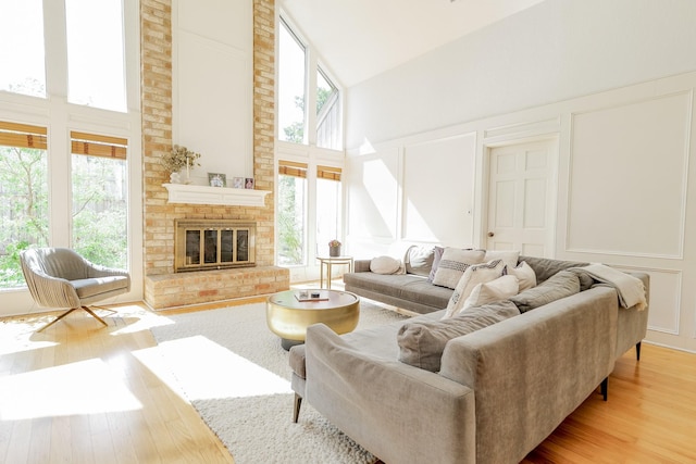 11810 Braesridge Dr, Houston, TX 77071 - living area featuring a towering ceiling, wood finished floors, a decorative wall, and a fireplace