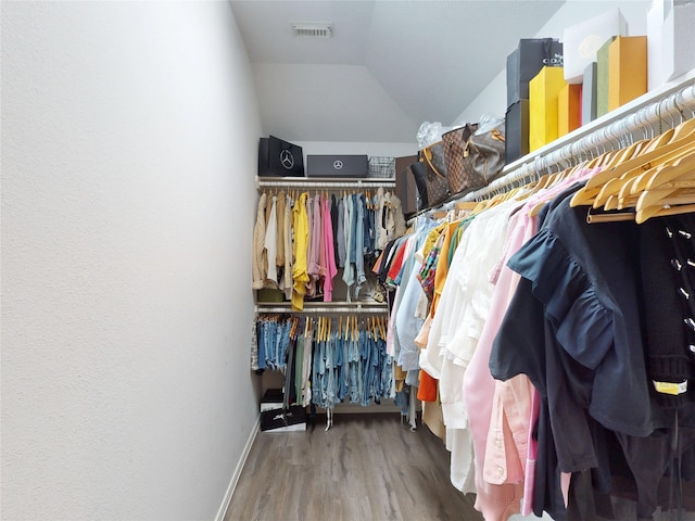 13931 Pueblo Run, Cypress, TX 77429 - spacious closet featuring vaulted ceiling and wood finished floors