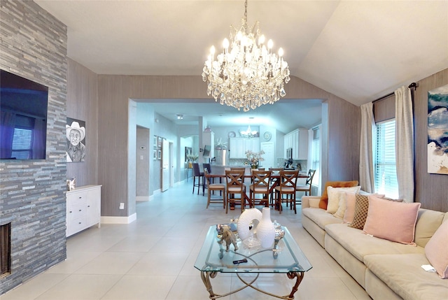 13931 Pueblo Run, Cypress, TX 77429 - living room featuring a chandelier, light tile patterned floors, vaulted ceiling, and a fireplace