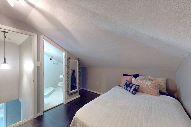 13931 Pueblo Run, Cypress, TX 77429 - bedroom featuring lofted ceiling, dark wood-type flooring, a textured ceiling, baseboards, and connected bathroom