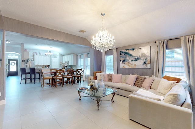 13931 Pueblo Run, Cypress, TX 77429 - living room featuring a chandelier, vaulted ceiling, plenty of natural light, and light tile patterned flooring