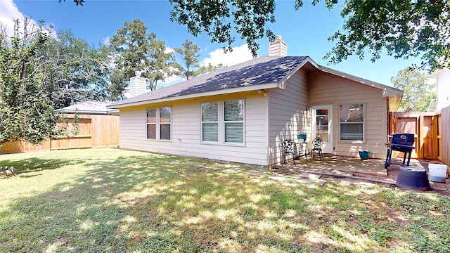 13931 Pueblo Run, Cypress, TX 77429 - back of house with a chimney and a patio