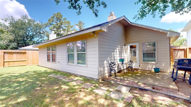 13931 Pueblo Run, Cypress, TX 77429 - back of house featuring a chimney and a patio area