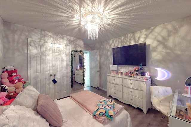13931 Pueblo Run, Cypress, TX 77429 - bedroom with a chandelier, wood finished floors, and a closet