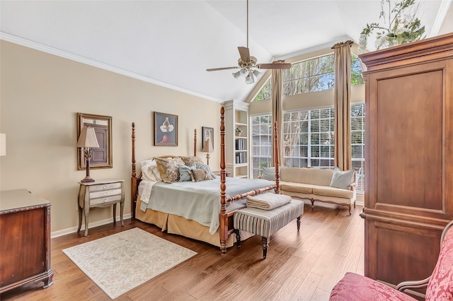 bedroom featuring vaulted ceiling, light wood-type flooring, ornamental molding, ceiling fan, and baseboards