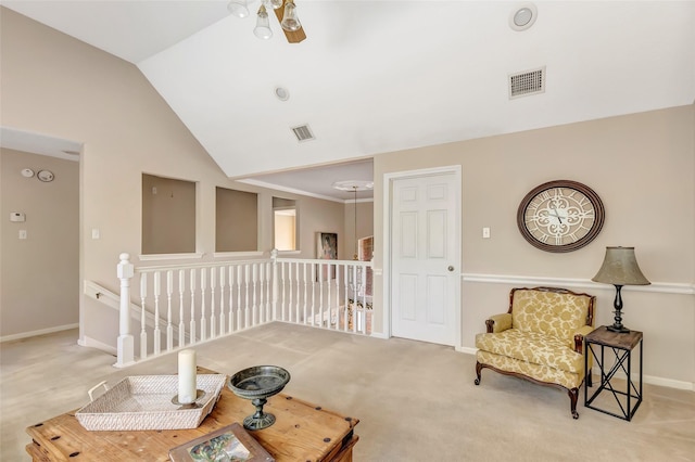 sitting room with an upstairs landing, lofted ceiling, baseboards, and carpet