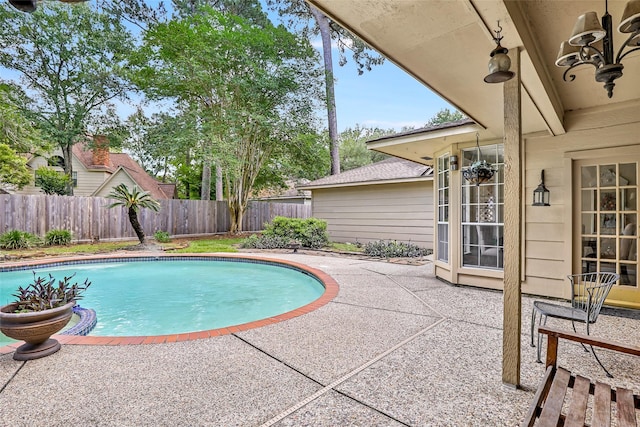 view of swimming pool with a patio and a fenced backyard