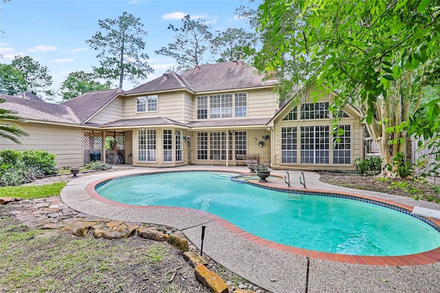 outdoor pool with a patio area and fence