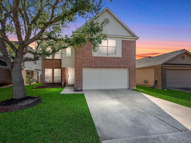 view of front facade featuring brick siding, an attached garage, driveway, and a front yard