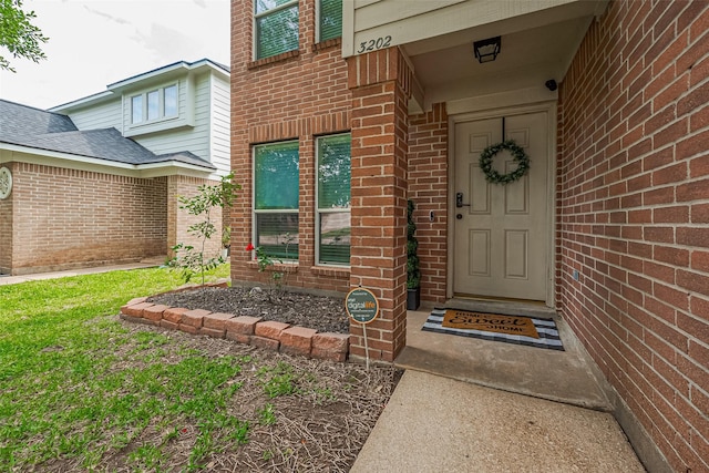 property entrance with brick siding