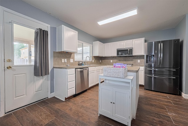 kitchen featuring stainless steel appliances, light countertops, a sink, and white cabinetry