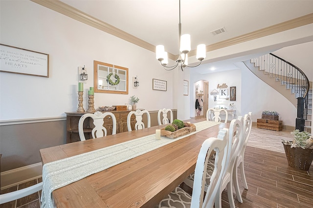 3911 Avalon Ridge Dr, Spring, TX 77386 - dining room with arched walkways, ornamental molding, stairs, wood finished floors, and a chandelier