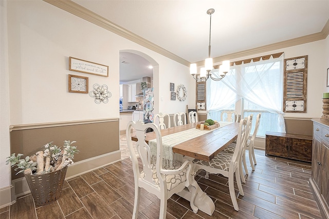 3911 Avalon Ridge Dr, Spring, TX 77386 - dining space with ornamental molding, wood tiled floors, a chandelier, arched walkways, and baseboards