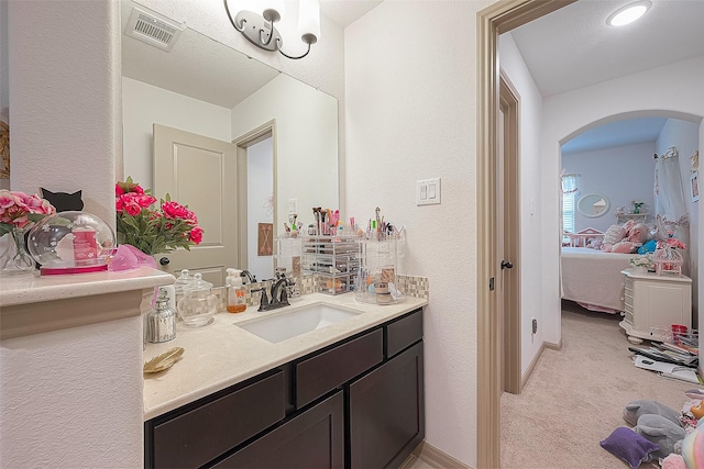 3911 Avalon Ridge Dr, Spring, TX 77386 - ensuite bathroom featuring a textured wall, vanity, and baseboards