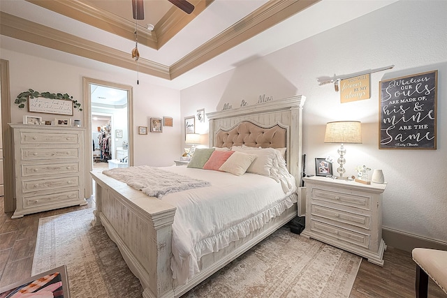 3911 Avalon Ridge Dr, Spring, TX 77386 - bedroom with crown molding, wood finished floors, a tray ceiling, a walk in closet, and a ceiling fan