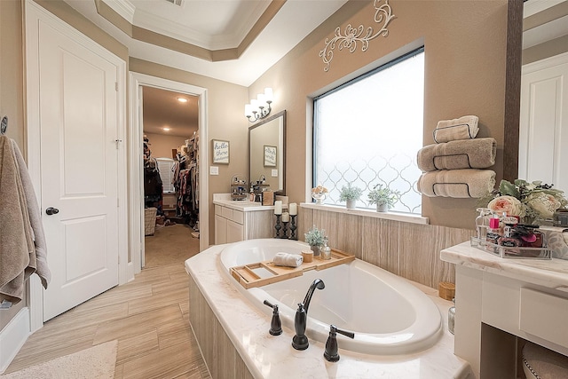 3911 Avalon Ridge Dr, Spring, TX 77386 - bathroom featuring a garden tub, crown molding, a walk in closet, and vanity