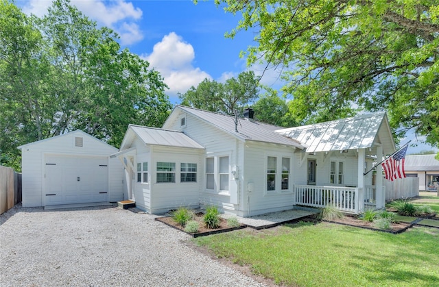 6020 State Highway 159, La Grange, TX 78945 - view of front facade featuring an outbuilding, gravel driveway, a garage, and metal roof