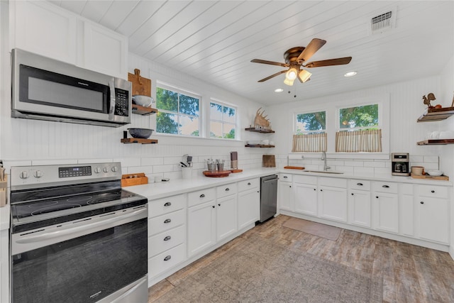 6020 State Highway 159, La Grange, TX 78945 - kitchen featuring open shelves, stainless steel appliances, a sink, white cabinets, and backsplash
