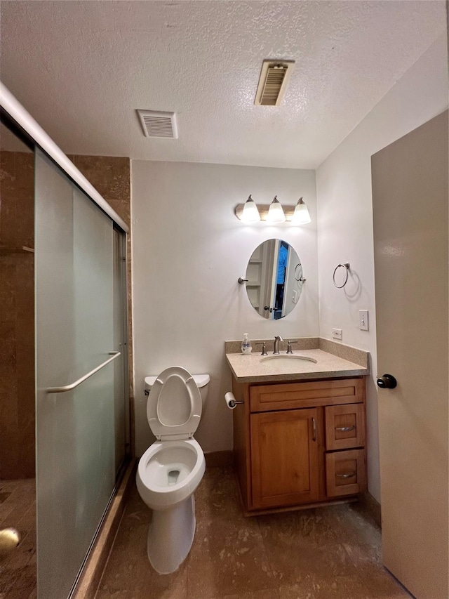 2930 Grants Lake Blvd Unit 2404, Sugar Land, TX 77479 - full bathroom with a shower stall, a textured ceiling, vanity, toilet, and baseboards