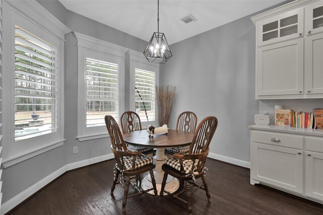 3315 Spring Branch Rd, Montgomery, TX 77316 - dining room featuring a chandelier, baseboards, and dark wood-style flooring