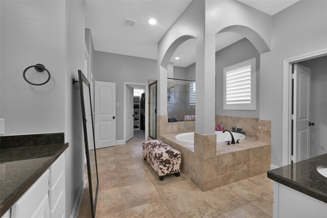 3315 Spring Branch Rd, Montgomery, TX 77316 - full bathroom with vanity, a garden tub, tiled shower, and a walk in closet