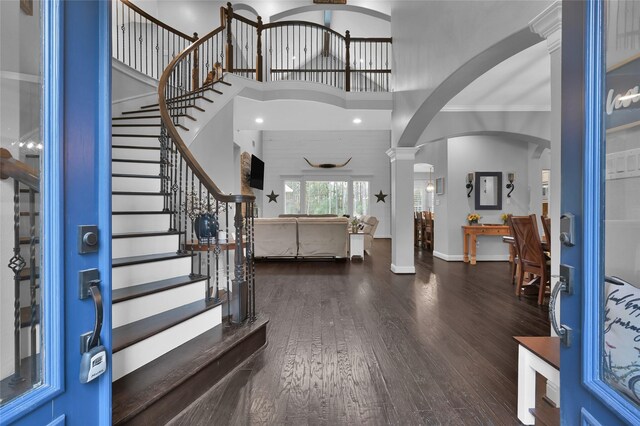 3315 Spring Branch Rd, Montgomery, TX 77316 - foyer featuring arched walkways, wood finished floors, ornate columns, stairs, and a towering ceiling