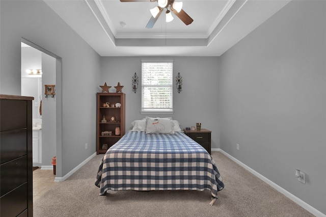 3315 Spring Branch Rd, Montgomery, TX 77316 - bedroom featuring a tray ceiling, light carpet, ornamental molding, ensuite bath, and ceiling fan