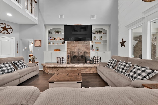 3315 Spring Branch Rd, Montgomery, TX 77316 - living area with a high ceiling, dark wood-style floors, built in features, baseboards, and a fireplace