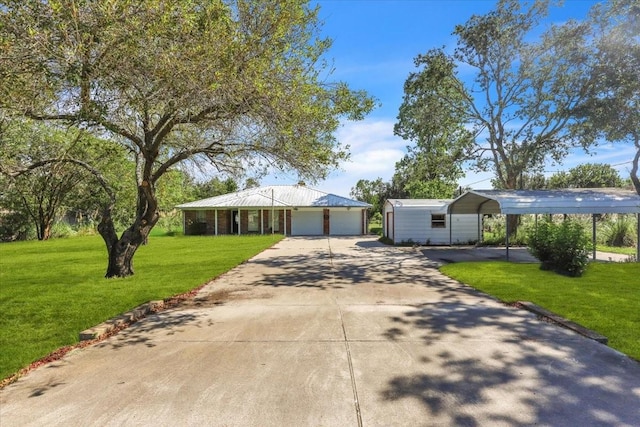 13519 Montgomery Rd, Santa Fe, TX 77510 - single story home featuring a front lawn, a carport, concrete driveway, and a detached garage