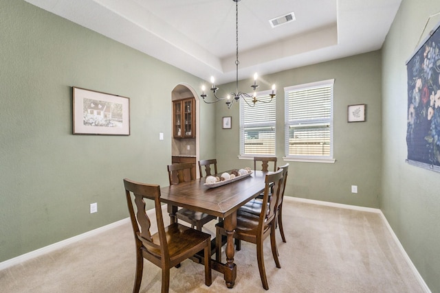 12019 Eagle Ridge Dr, Dayton, TX 77535 - dining area featuring light carpet, arched walkways, a chandelier, and baseboards