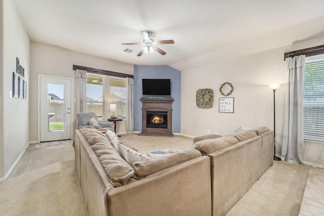 12019 Eagle Ridge Dr, Dayton, TX 77535 - living room featuring a ceiling fan, a warm lit fireplace, baseboards, and light carpet