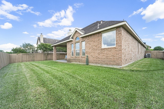 12019 Eagle Ridge Dr, Dayton, TX 77535 - rear view of house with brick siding, central air condition unit, a patio, and a shingled roof