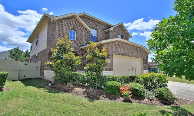 view of side of home with brick siding, a garage, and concrete driveway
