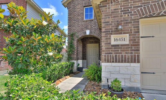 property entrance with brick siding