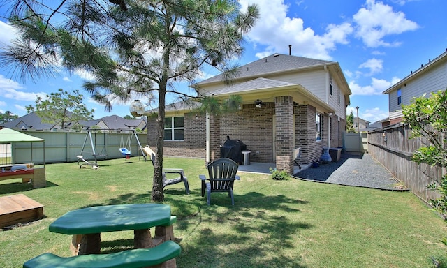 back of house with brick siding and a patio area