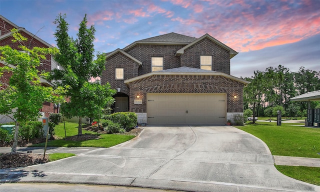 view of front facade featuring brick siding, driveway, a garage, and a front lawn