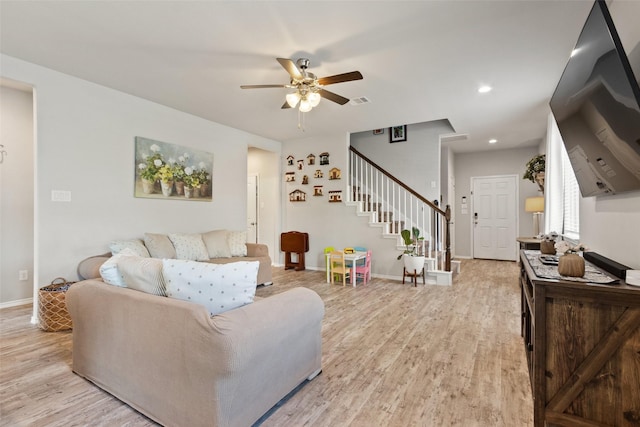 living room with stairway, light wood-style flooring, a ceiling fan, baseboards, and recessed lighting