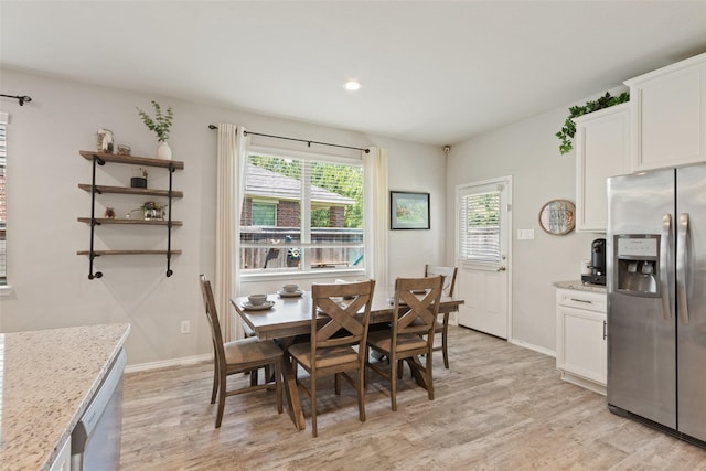 dining area with light wood finished floors, baseboards, and recessed lighting